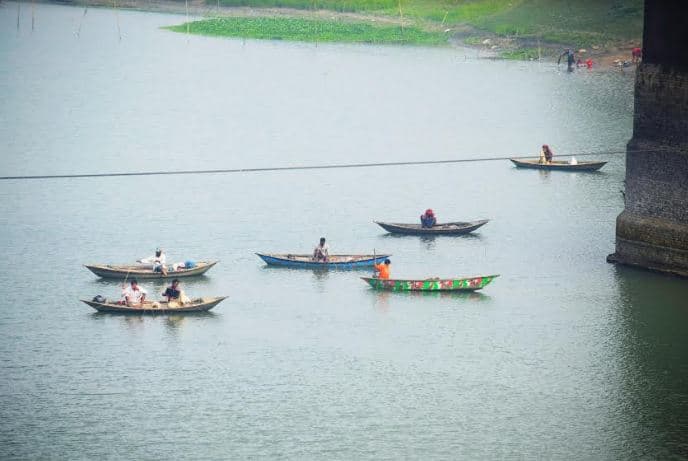 ফুলজোড় নদীতে ছিপ দিয়ে মাছ ধরতে ব্যস্ত মাছ শিকারীরা