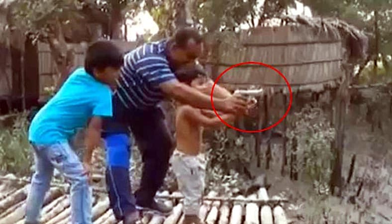 শিশুপুত্রকে অস্ত্র চালানোর প্রশিক্ষণ বিচারক বাবার ! ভাইরাল ভিডিও