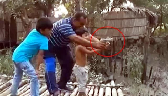 শিশুপুত্রকে অস্ত্র চালানোর প্রশিক্ষণ বিচারক বাবার ! ভাইরাল ভিডিও